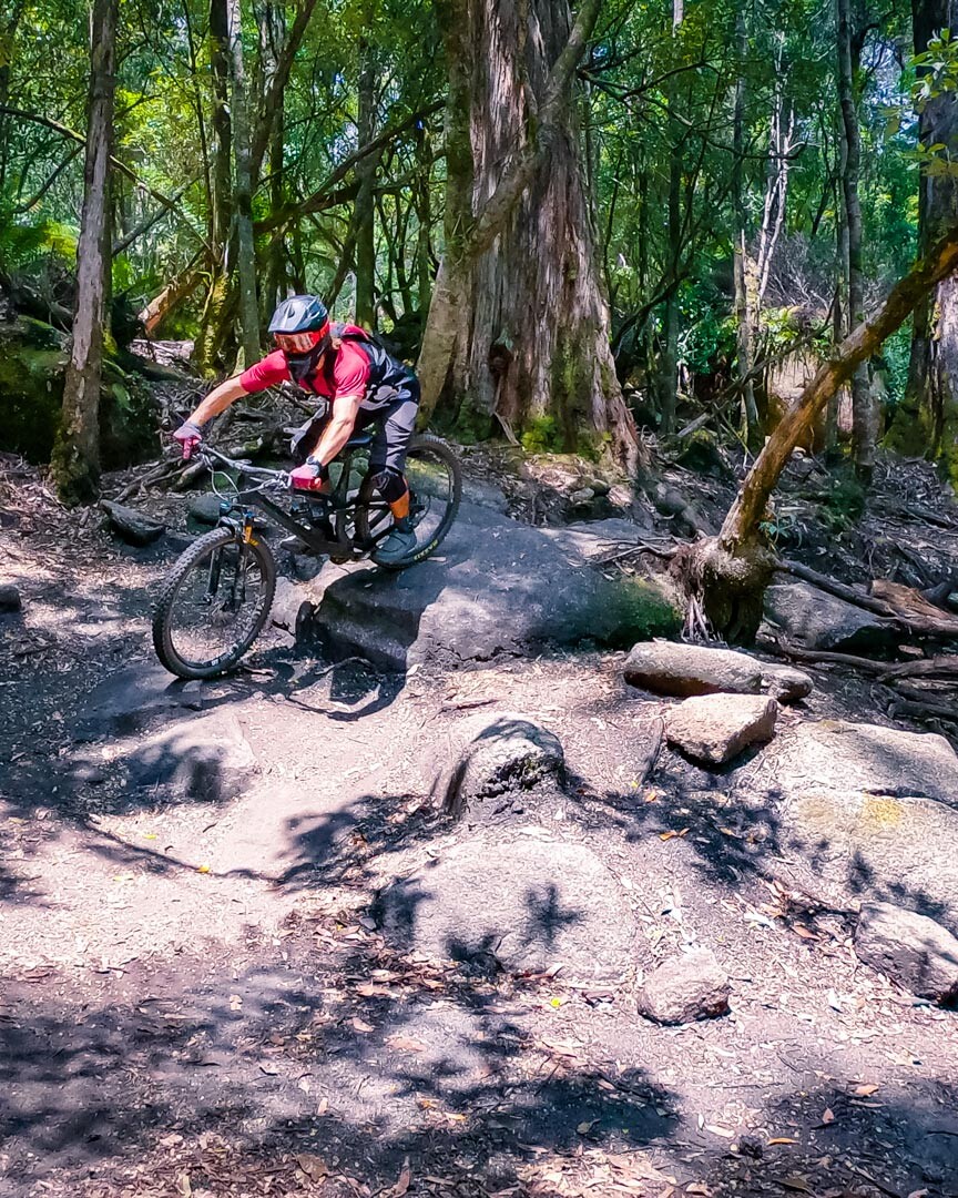 Mountain biking down the rock gardens found on the Blue Tier and Atlas Trail in Blue Derby Tasmania