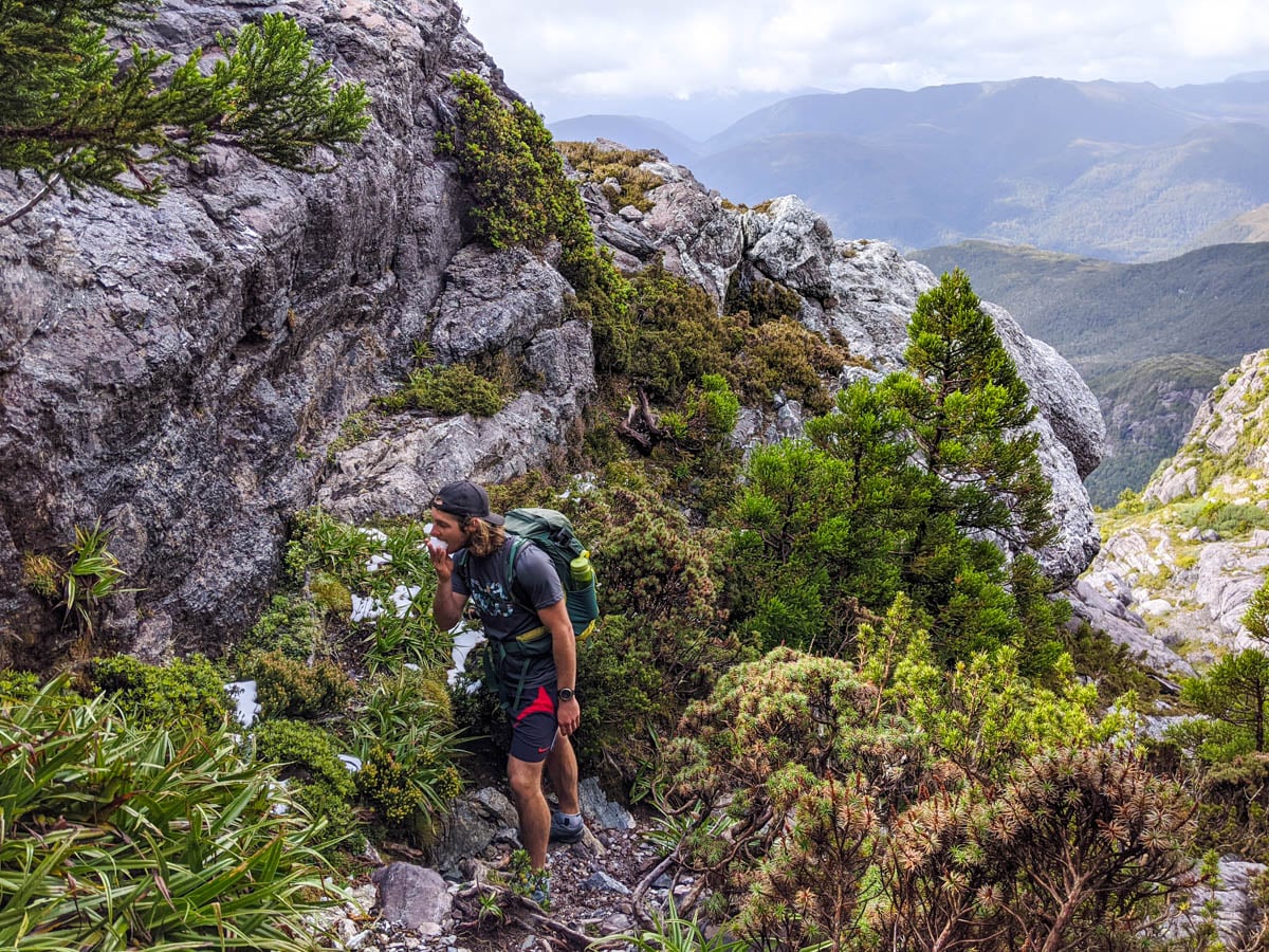 Snacking on ice while Climbing Mount Murchison Tasmania showing how we love snacking and why you should hike