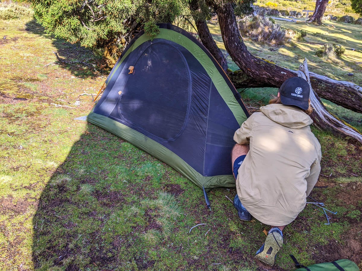 Pitching a tent in the Dixons Kingdom Campsite at the Walls Of Jerusalem National Park showing why you should hike