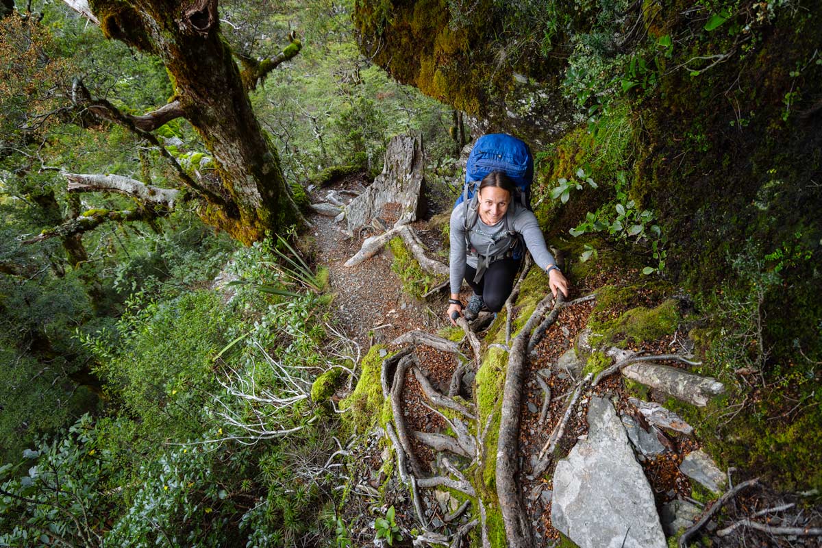 Climbing a steep hiking trail in New Zealand wearing hiking tights